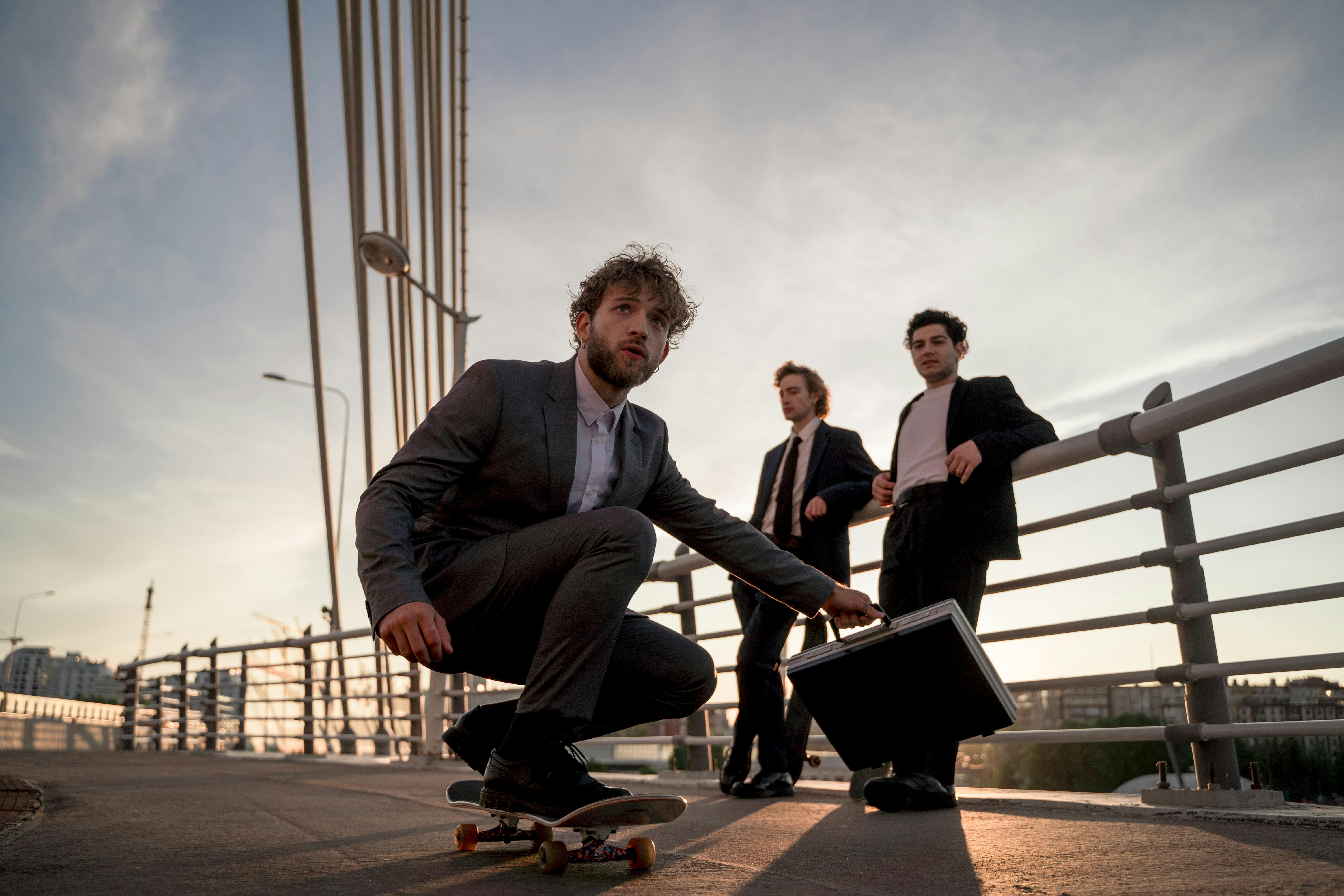 man in gray suit riding a skateboard