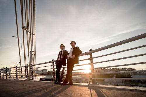 Two Men Standing on Bridge