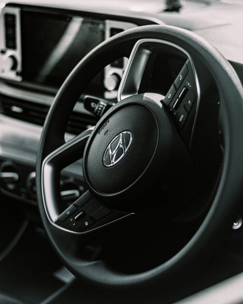 Free Detailed view of a vehicle's steering wheel with dashboard features, perfect for automotive themes. Stock Photo