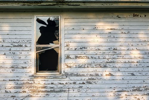 Old Wooden House with Broken Glass Window 
