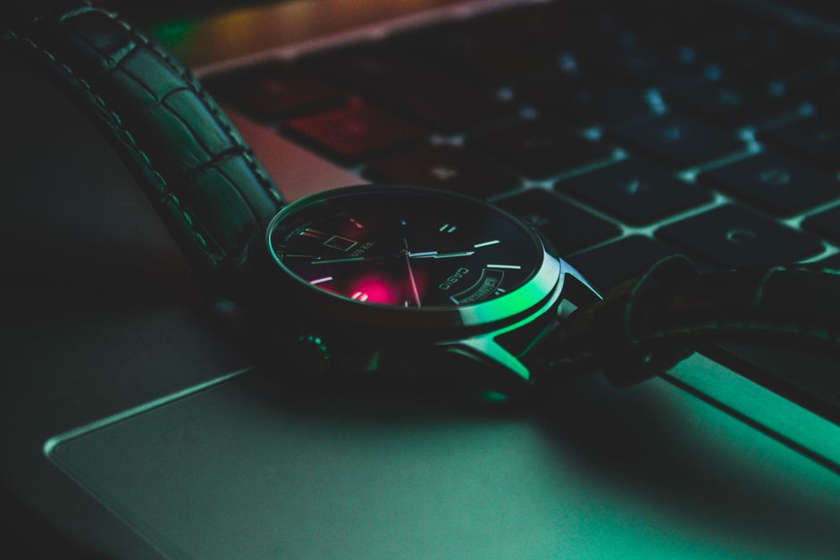 Close-up of a stylish analog wristwatch resting on a laptop keyboard, highlighting luxury and technology. Close-up of a stylish analog wristwatch resting on a laptop keyboard, highlighting luxury and technology.