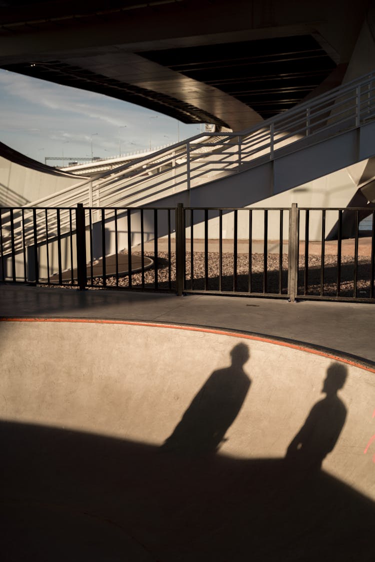 Shadows Of Two People On Skate Ramp