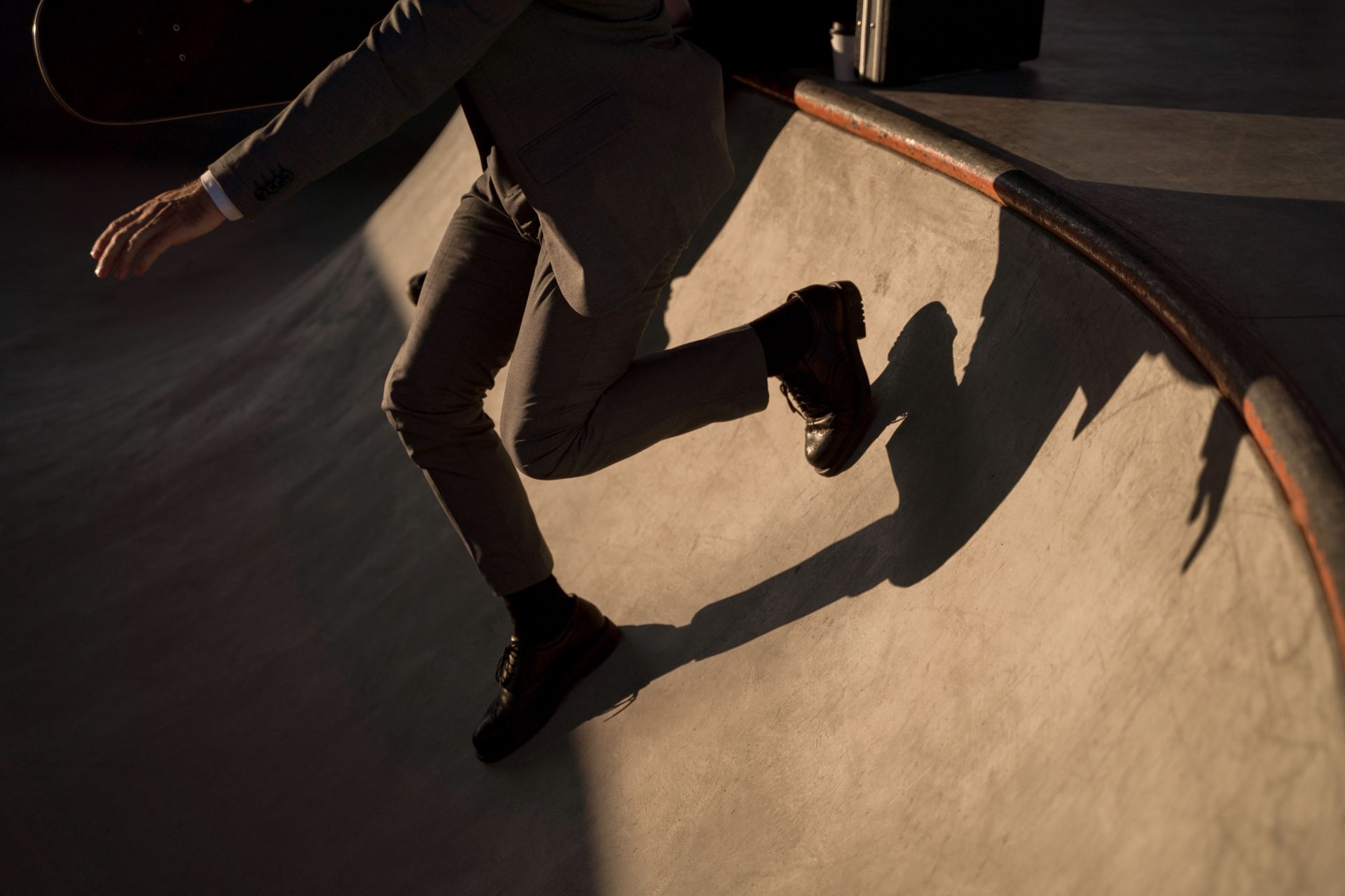 A Person in Black Leather Shoes Standing on a Ramp