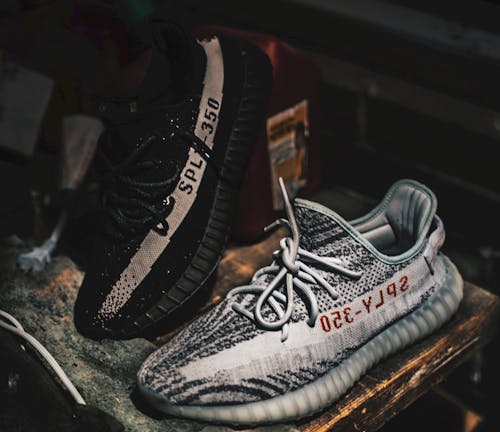 Free Two Unpaired Black and Gray Adidas Sply-350 V2 Stock Photo