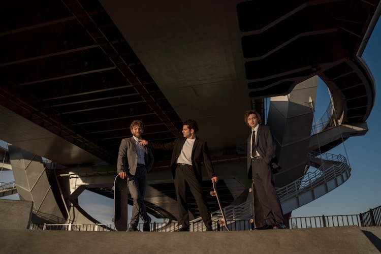 Men Wearing Suits Standing On Top Of A Ramp