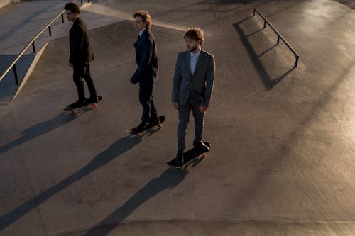 Men in Suits Skateboarding 