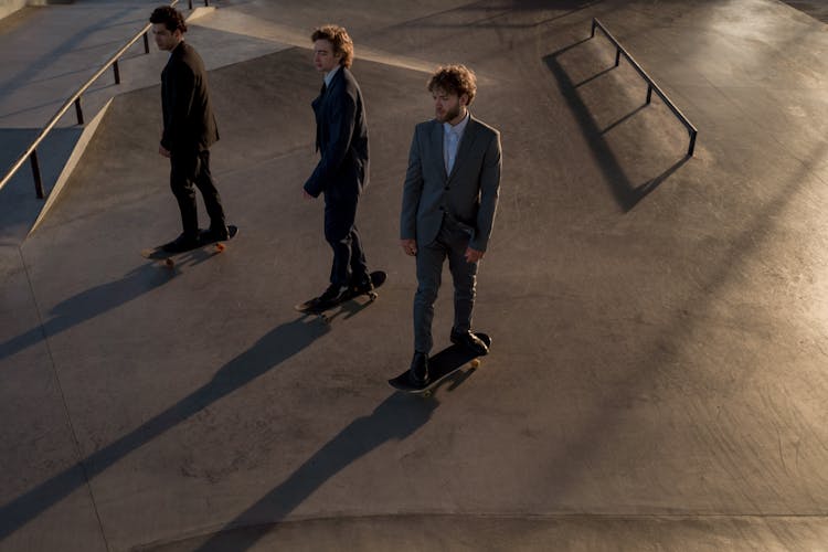 Men In Suits Skateboarding 