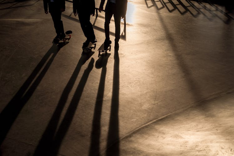 Group Men Skateboarding On A Skate Park