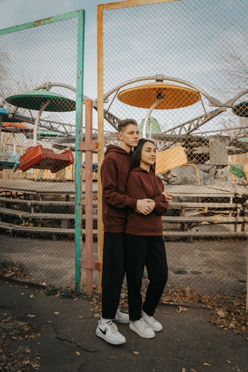 Young Couple outside of a Closed Amusement Park 