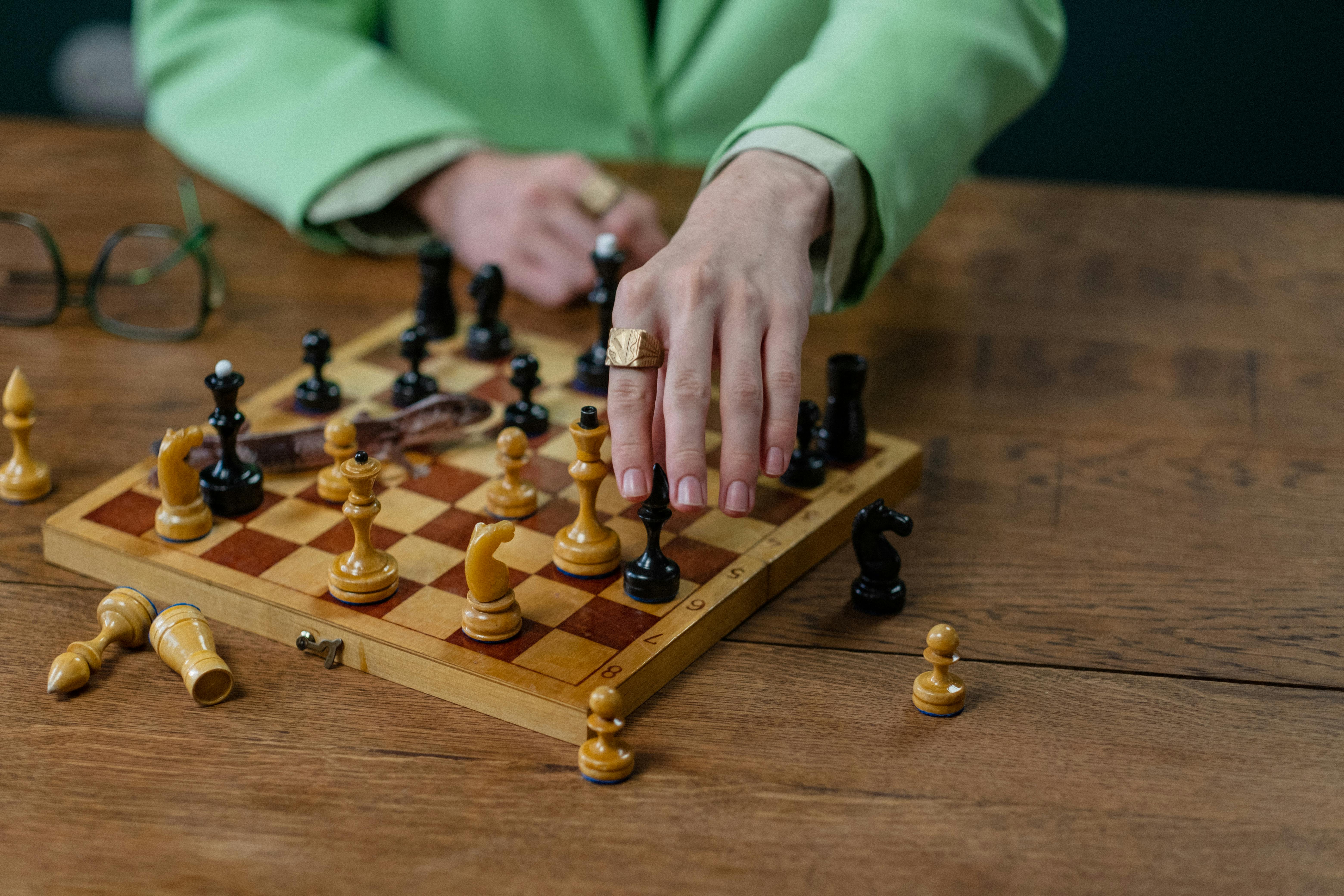 man in green suit playing chess