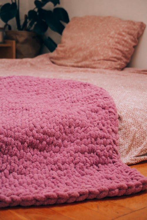 Free A Bed with Pink Bedsheet on the Ground Stock Photo