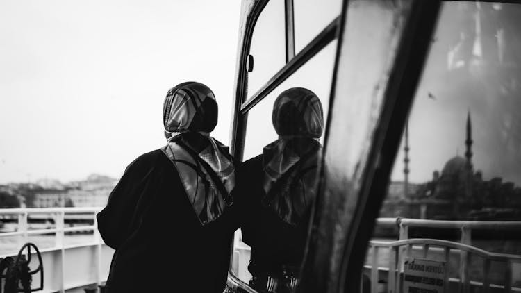 Black And White Photo Of Woman On Ferry