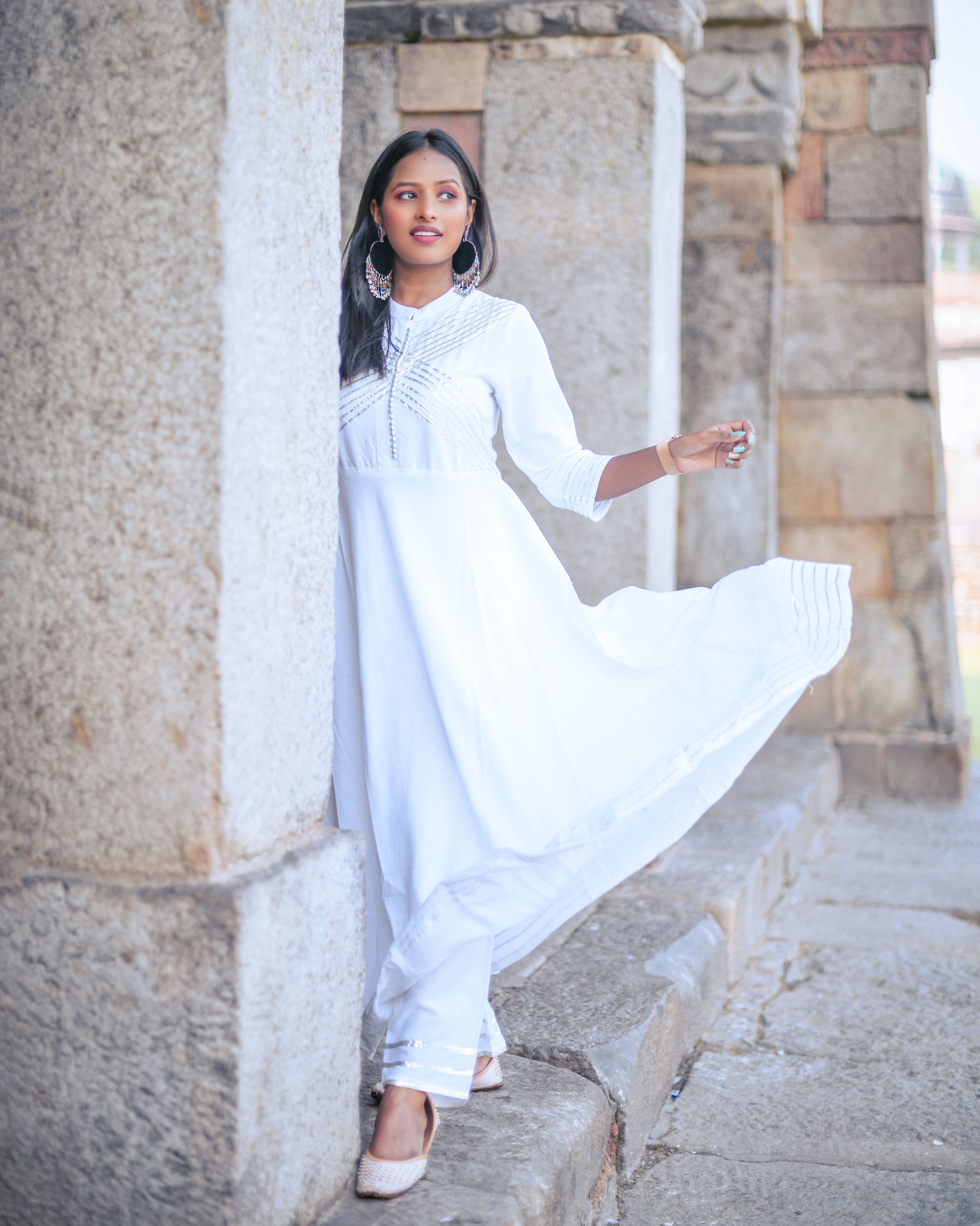 Woman in White Long Dress Standing Near a Concrete Wall while Looking ...