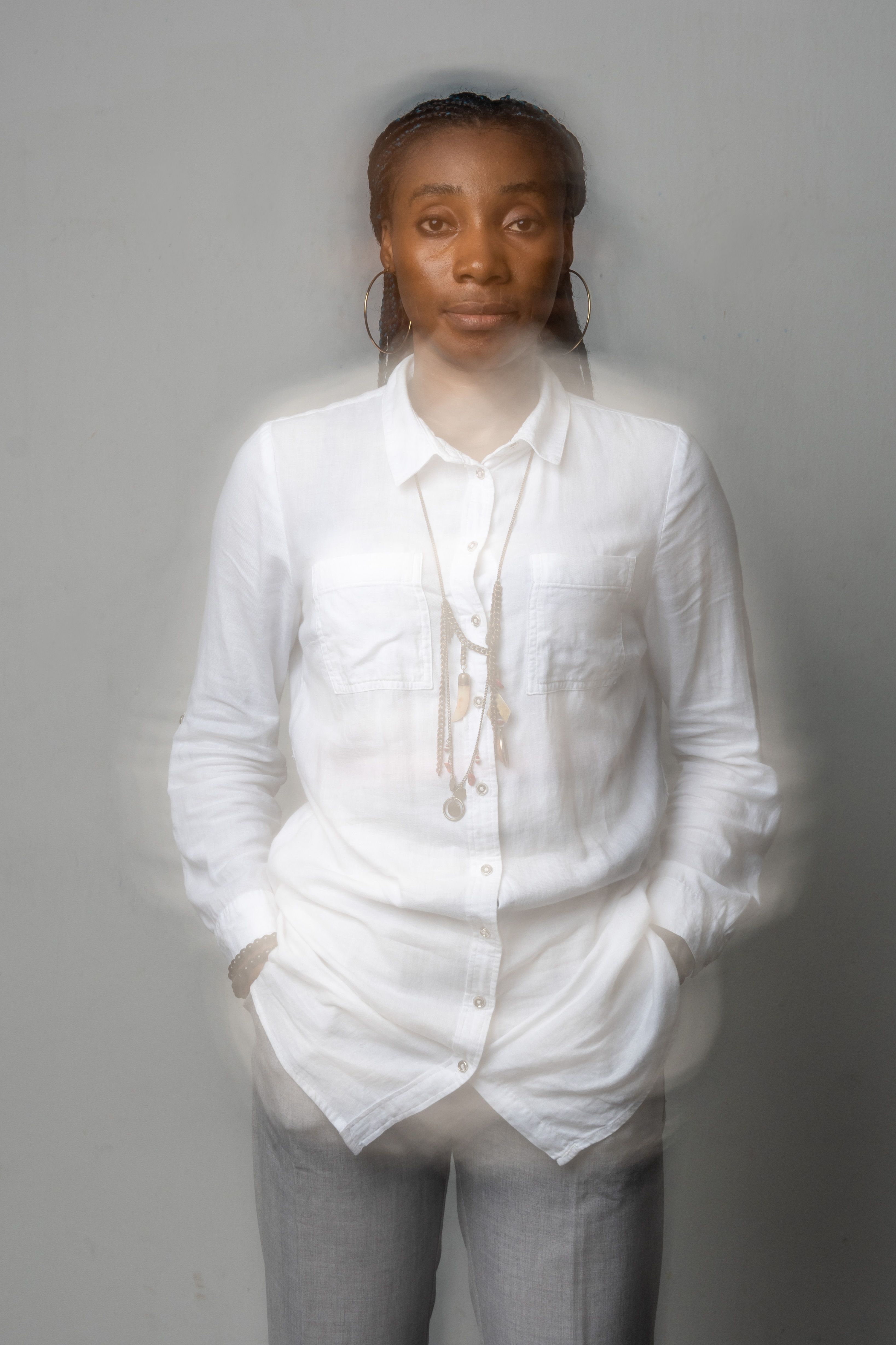 Blurred Shot of a Woman in White Long Sleeves Seriously Looking at the ...