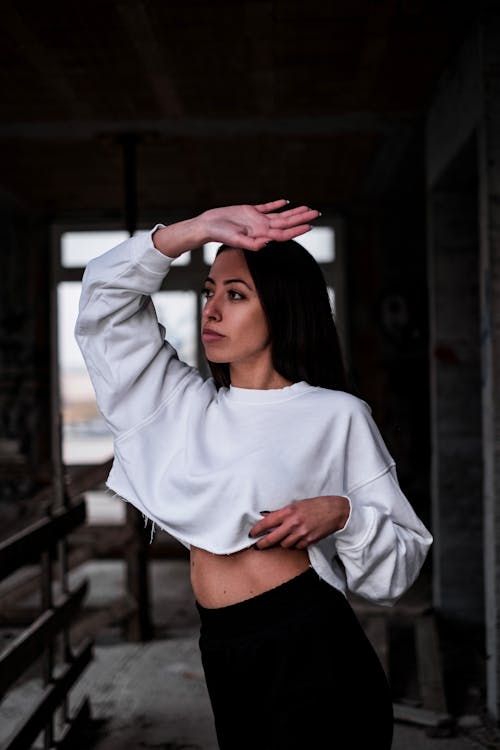 A Sexy Woman in Black Long Sleeves Crop Top and Denim Jeans