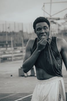 Intense portrait of a sweaty athlete outdoors, capturing effort and determination.