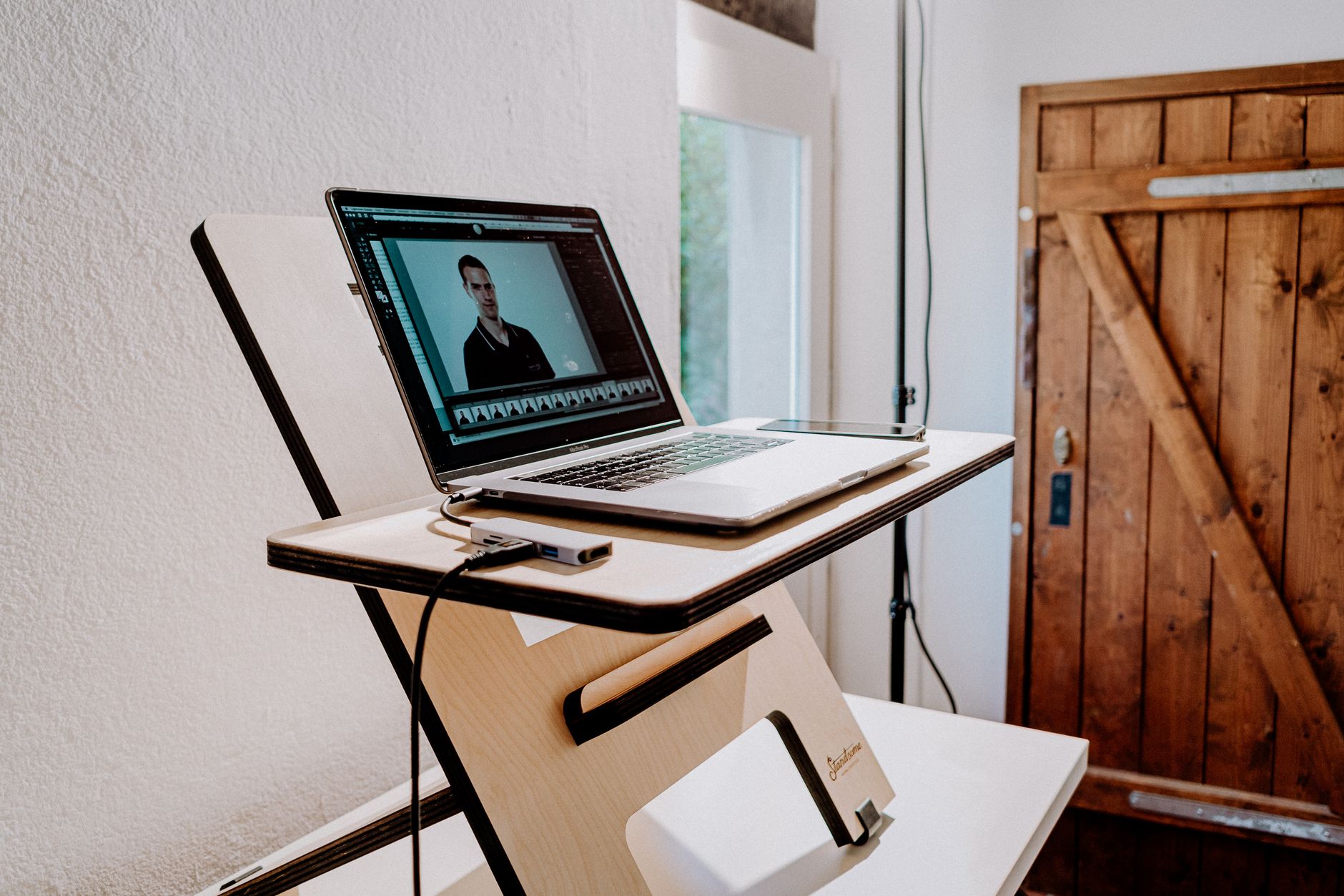 A modern workspace featuring a laptop on a sleek wooden desk, perfect for home or office settings.