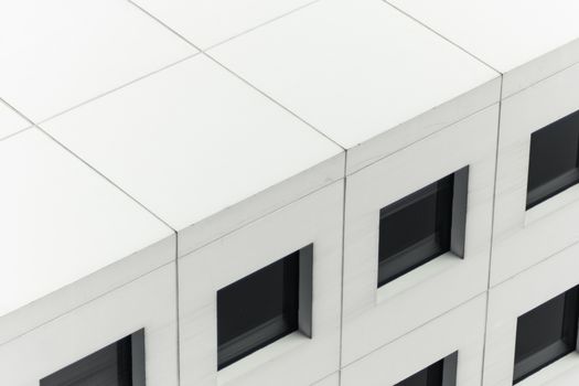 Close-up view of a modern building facade highlighting symmetrical windows.