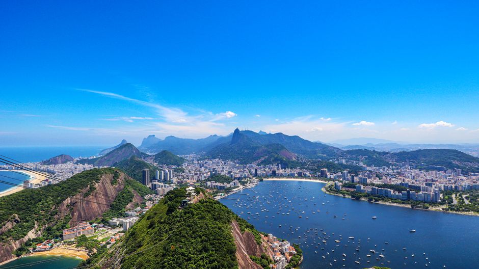 Stunning Rio de Janeiro: 35 Min Helicopter Tour Christ the Redeemer Review Review 2026 - Stunning aerial view of Rio de Janeiro's coastline, mountains, and cityscape under a clear blue sky.