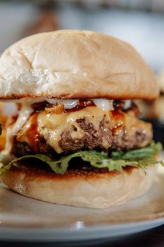 Delicious cheeseburger with lettuce, cheese, and ketchup on a bun.