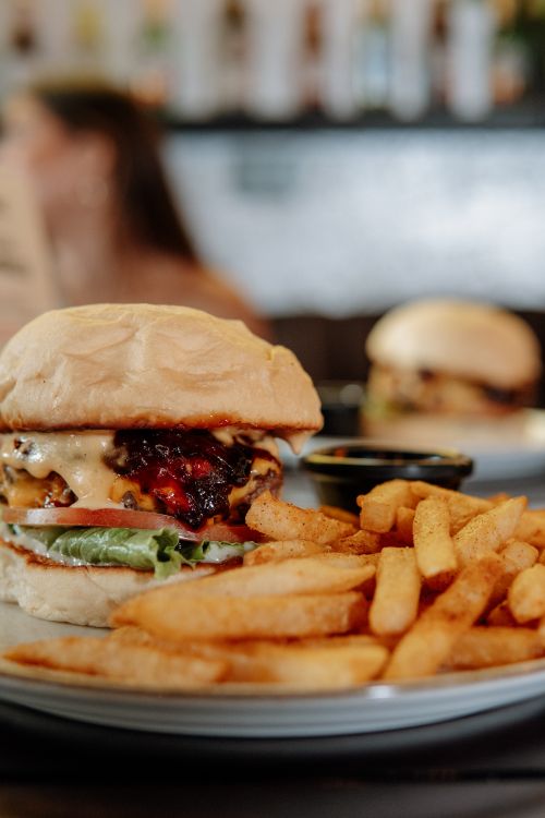 Free Delicious cheeseburger with fries, perfect for fast food lovers. Stock Photo