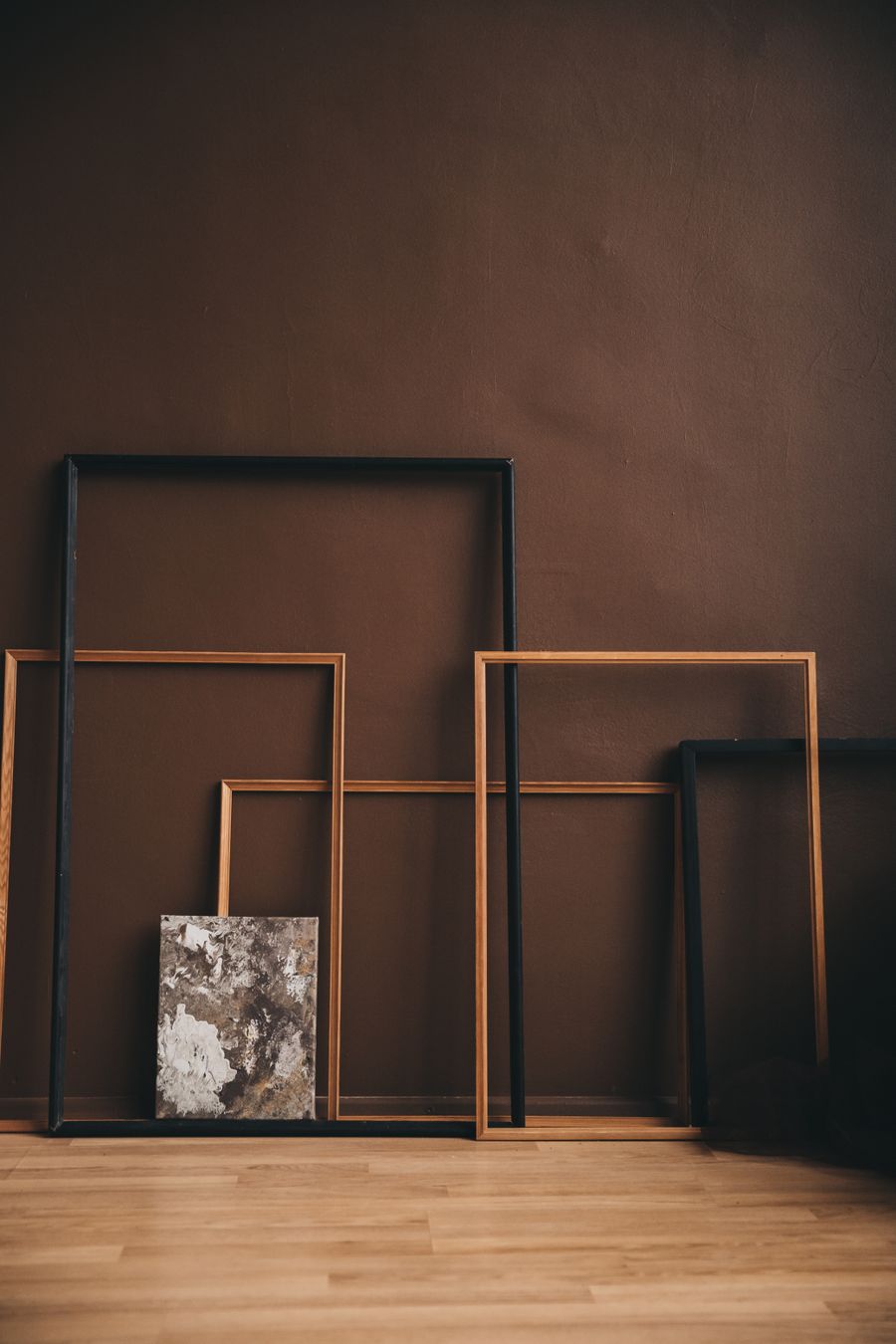 Empty frames leaning together in an art studio