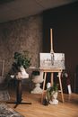 Painting on an Easel and Bust Sculptures on a Room