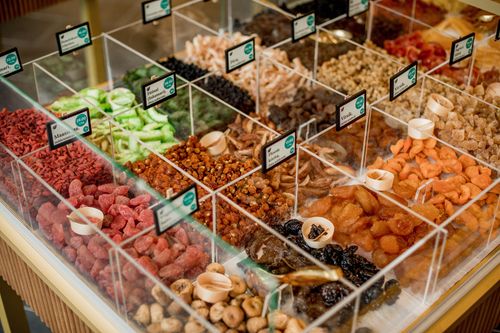 Free A vibrant selection of dried fruits in transparent containers at a market stall. Stock Photo