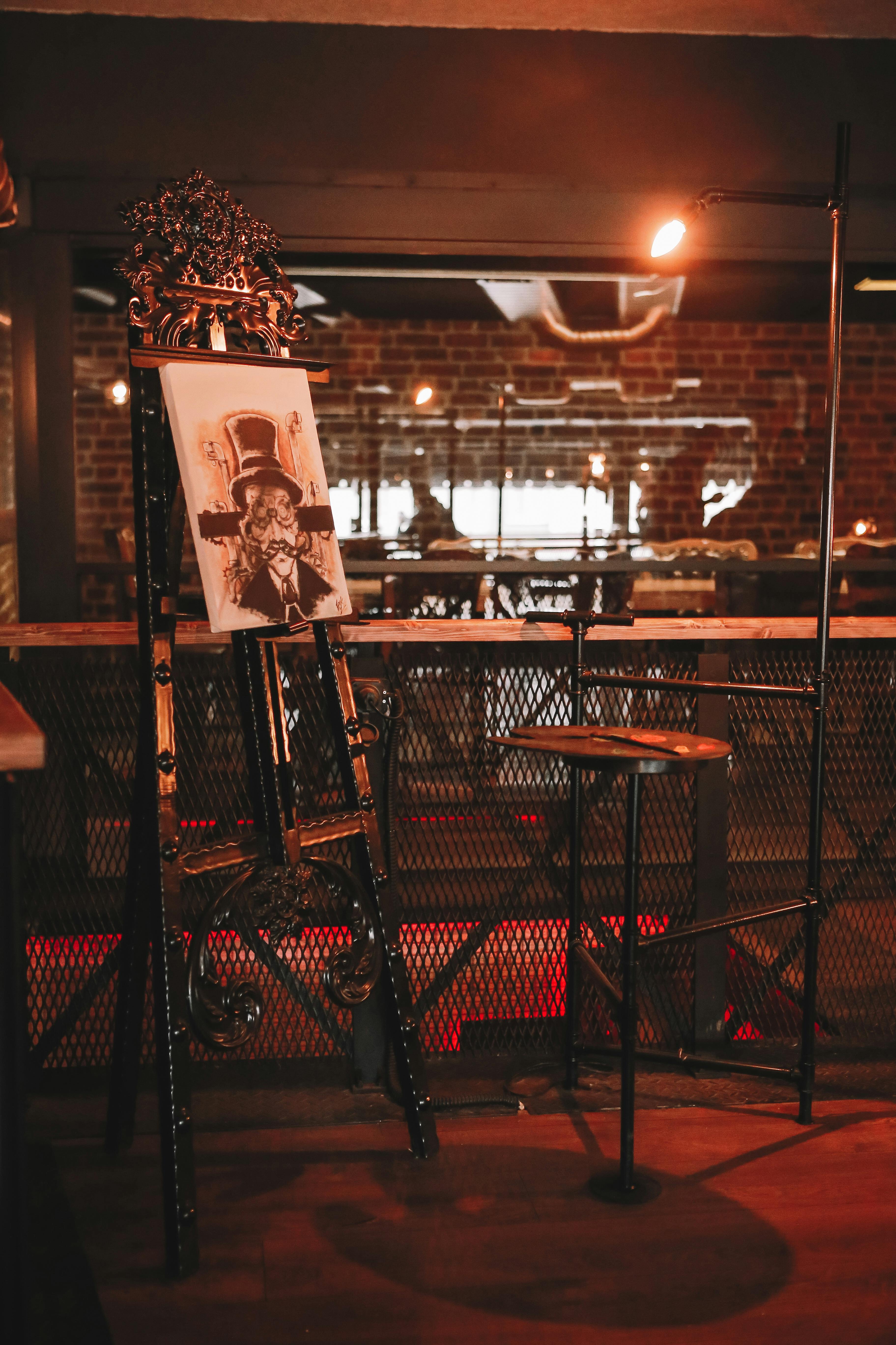 A Canvas Paint on Black Metal Paint Stand · Free Stock Photo