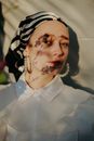 Portrait of Woman with Shadow of Flowers on Face