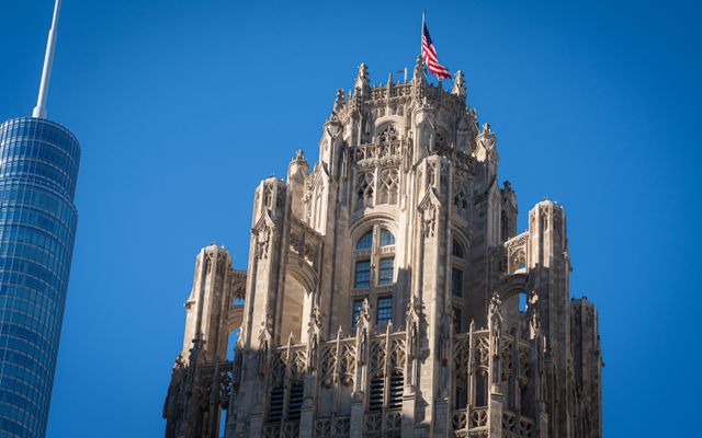 Photo: Otto Rascon on Pexels The historic Tribune Tower in Chicago, featuring its gothic architecture and American flag.