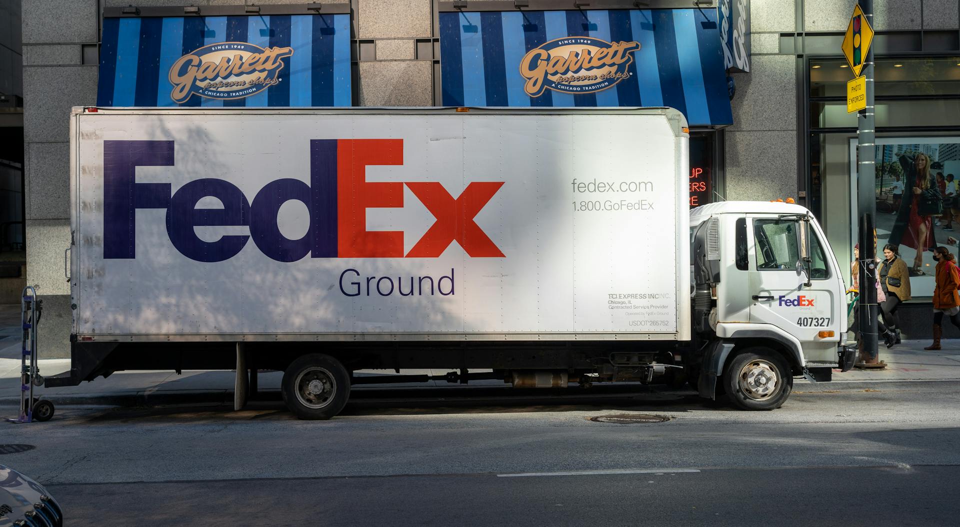 FedEx delivery truck parked on an urban street, highlighting city logistics.