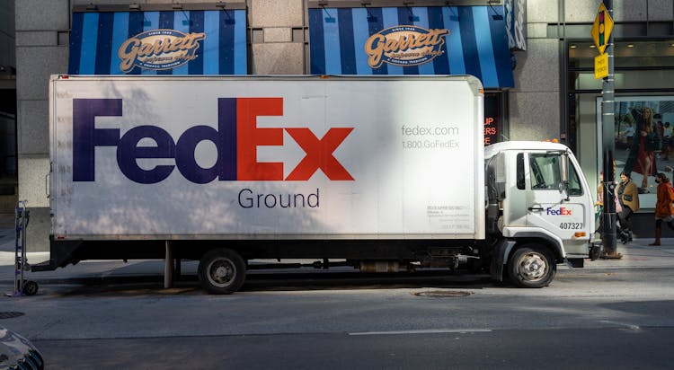 Fed Ex Truck Parked On The Side Of The Road 