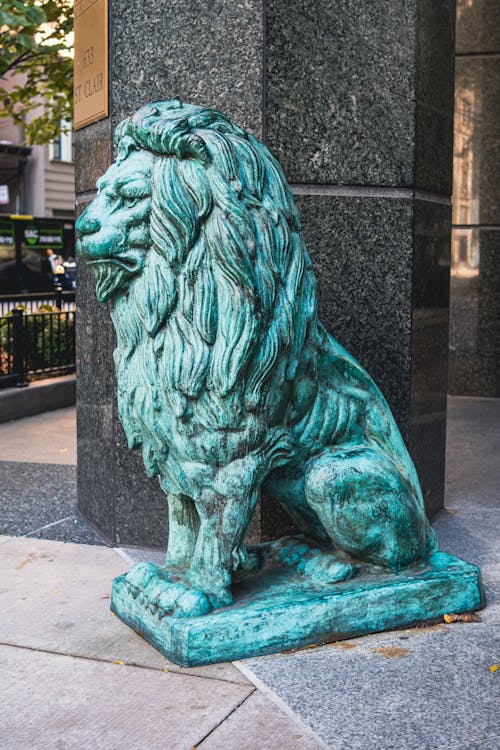 Lion Statue Beside the Wall of a Building
