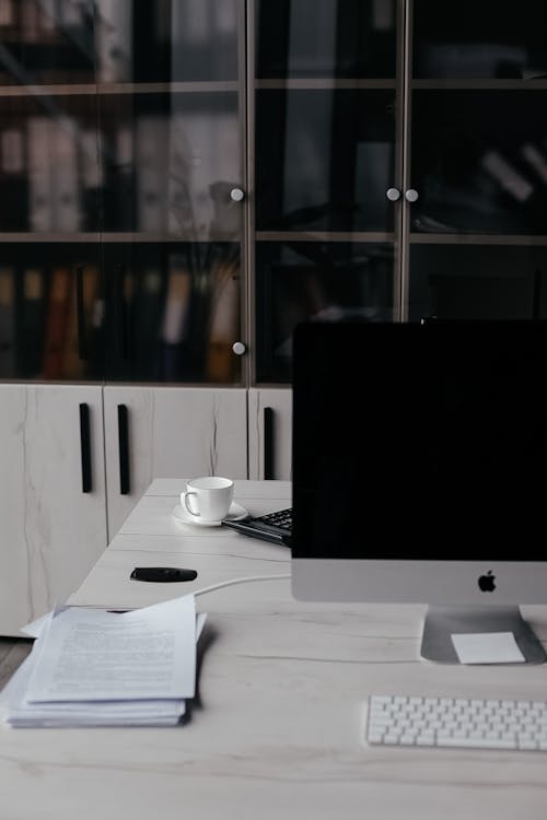Silver and Black Imac on White Table