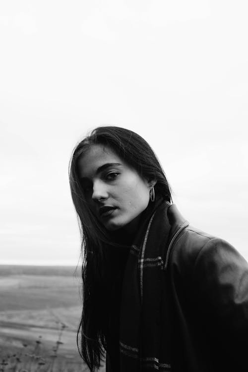 Grayscale Photo of Woman in Black Leather Jacket