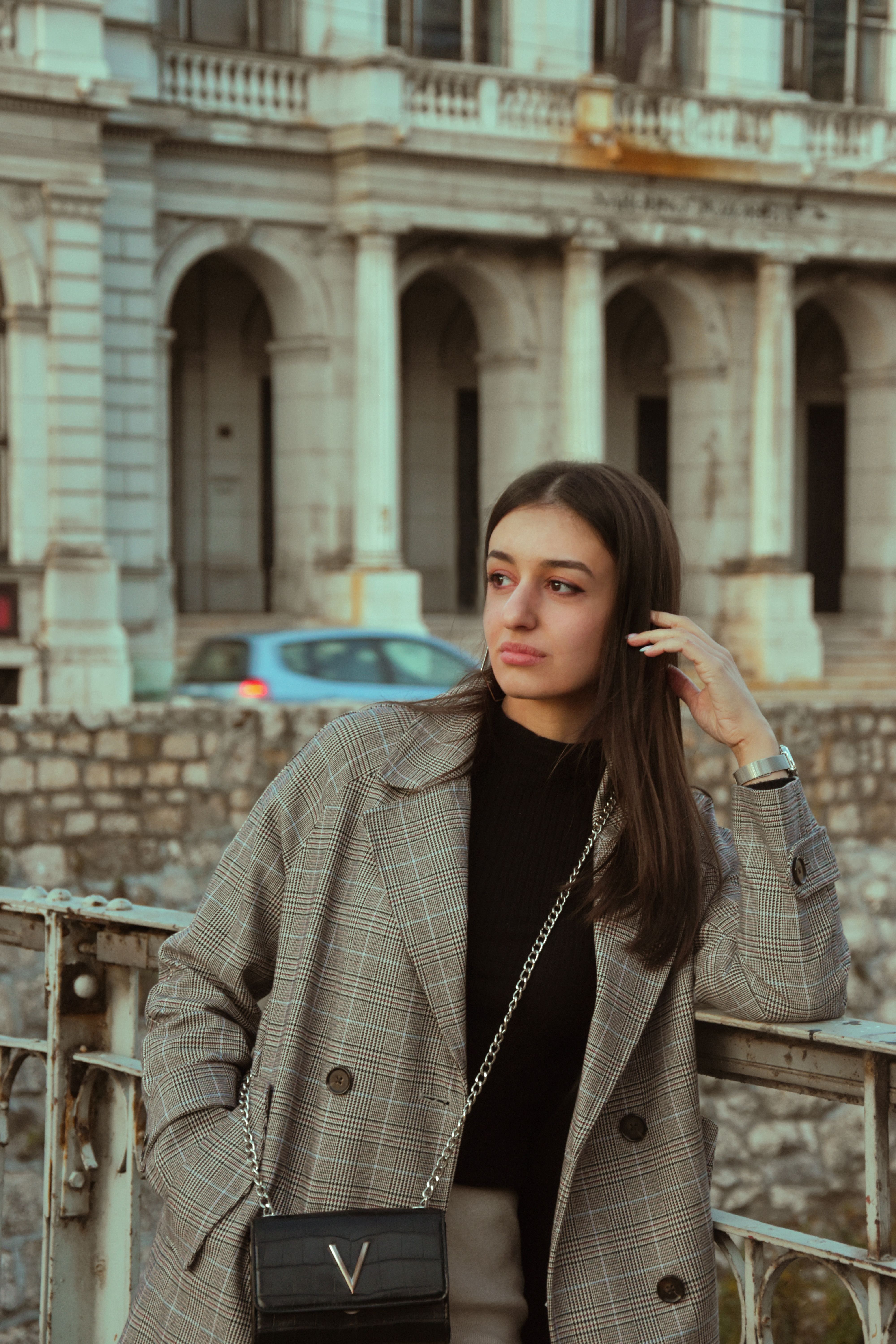 Woman in Black Coat Walking on a Bridge · Free Stock Photo