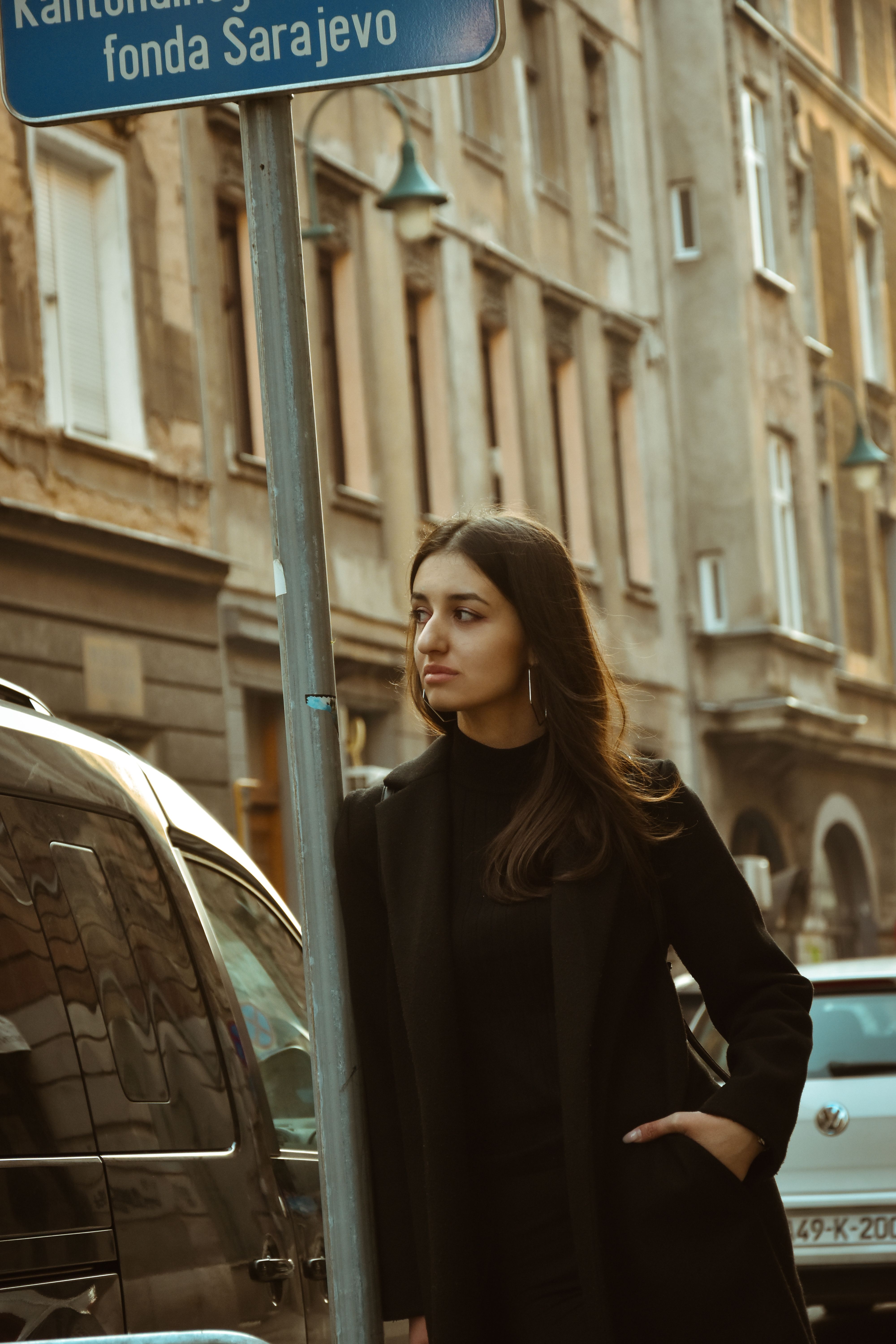 Woman in Black Outfit Standing on Sidewalk · Free Stock Photo
