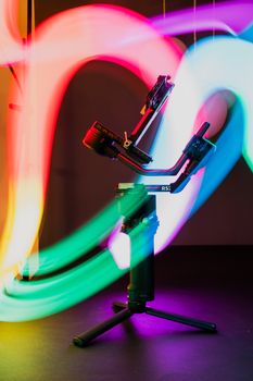 Gimbal captured in a creative setup with vibrant, colorful light trails, illustrating modern technology.