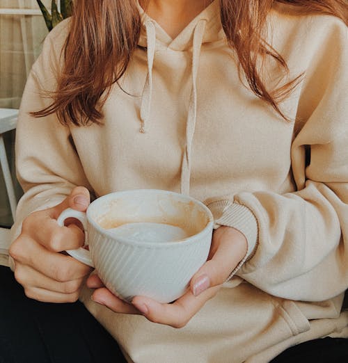 Close Up Photo of Woman Holding a Cup