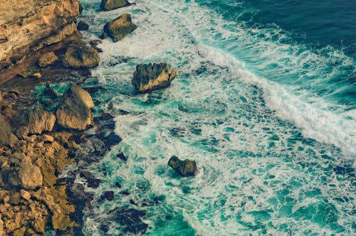 Brown Rock Formation on Body of Water