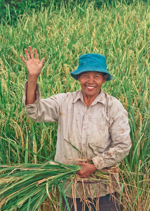 Woman Wearing Blue Bucket Hat Holding Crops