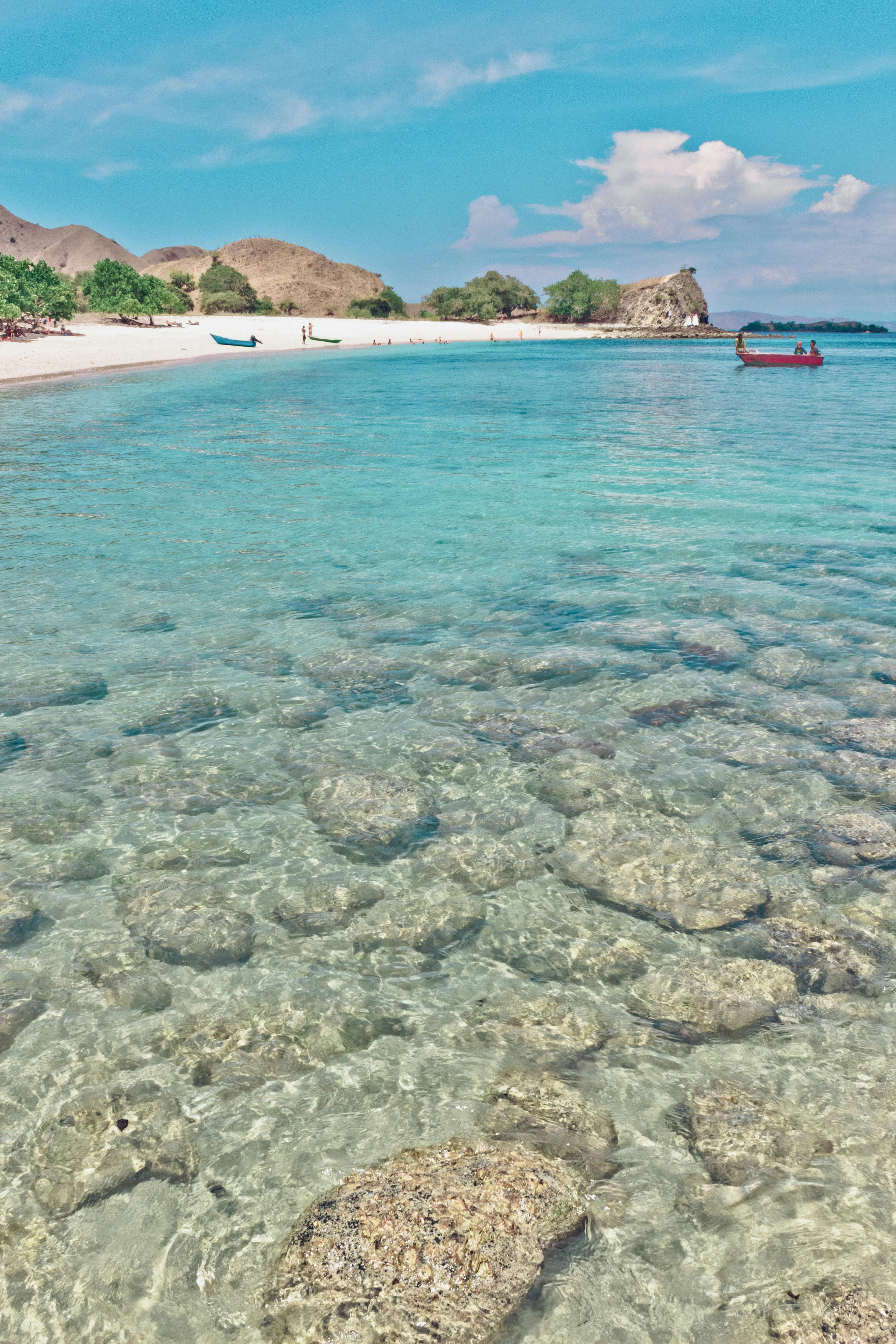 Calm shallow reef-protected water and soft sand on a Nusa Dua beach in Bali