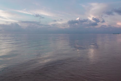 Body of Water Under Cloudy Sky