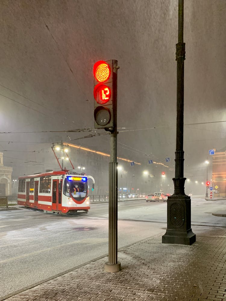 Red Stoplight By The Street And A Tram