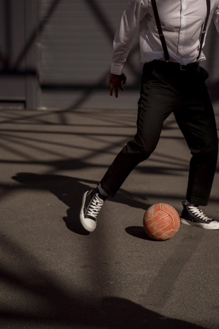 A Man Kicking A Ball