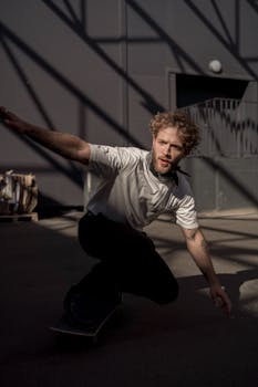 Energetic skateboarder in motion captured in urban shadow play, emphasizing agility.