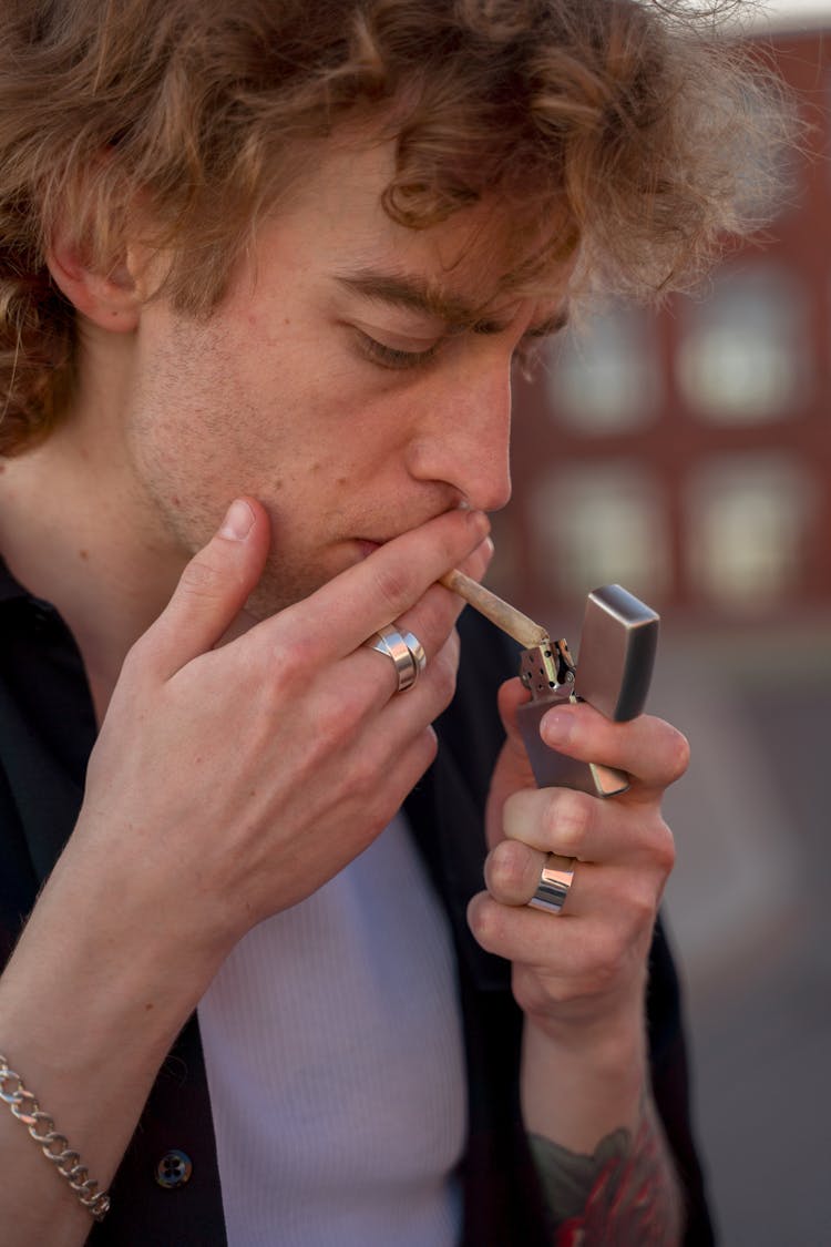 A Man Lighting A Cigarette 