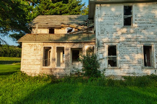 An Old Abandoned House on Green Grass Field