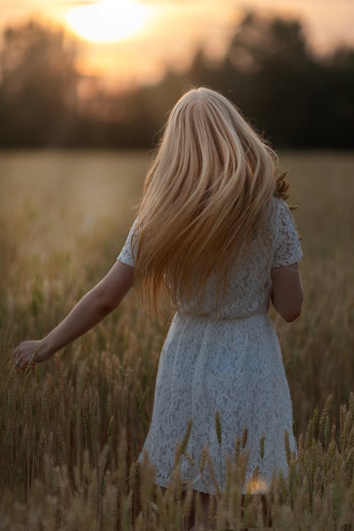 Woman in White Dress Standing in the Field